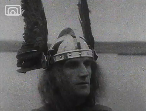 Black and white image of a man with viking helmet